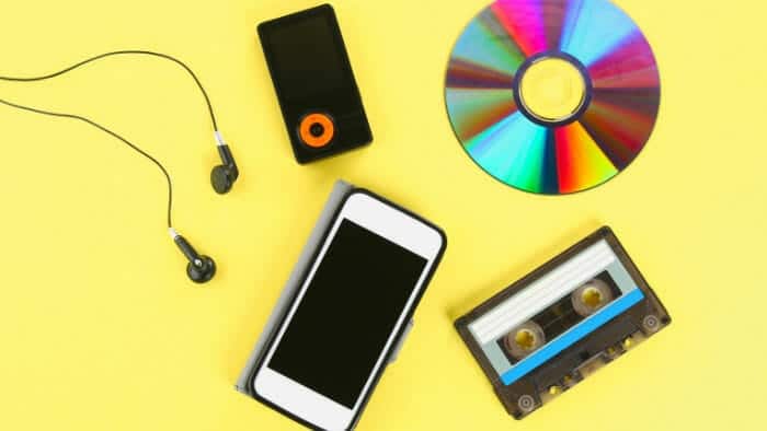 cassette next to a phone and an mp3 player