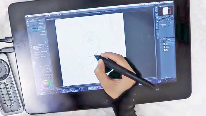 woman drawing a figure freehand style on a drawing display