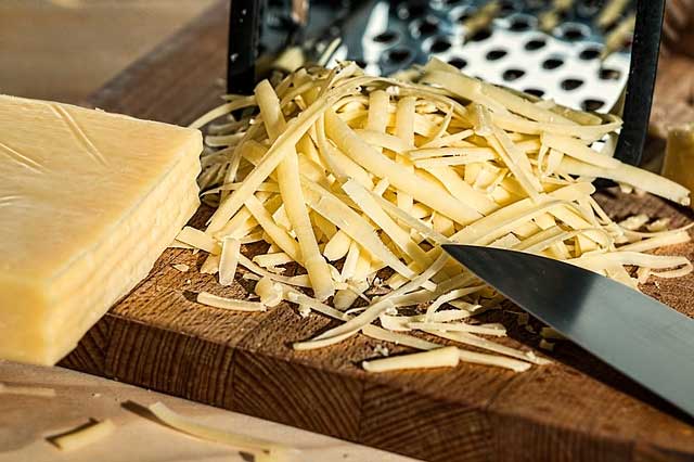 grated cheese on a wooden table