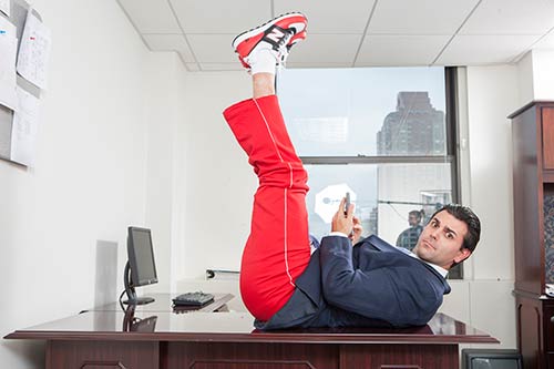 Business person exercising on his desk