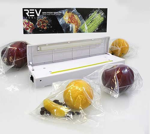 Impulse food sealer next to fruits and vegatables sealed in plastic bags