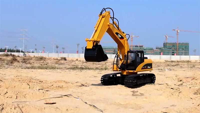 top race excavator toy on sand